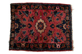 Vintage Lilihan hand knotted rug with raspberry red field, stepped medallion, navy floral design.