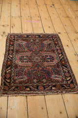 Vintage Lilihan rug corner displaying intricate floral bouquet design in raspberry, navy, and ivory.