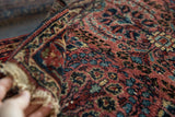 Thousand flower floral bouquet motif on raspberry and navy Lilihan rug pile texture.