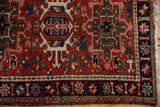 Vintage Karaja rug border, navy with starburst blossoms, intricate field, and fringe.