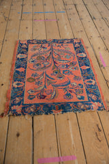Dusty blush Lilihan rug with expressive tree of life motif, cobalt floral border, and tattered edges.