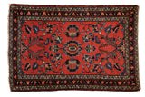 Vintage Persian Lilihan rug with red field, central pomegranate medallion, navy and jade florals.