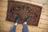 Hand-knotted Josan Sarouk rug's deep red and navy floral, pearl seed pattern with vinery.