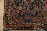 Vintage Josan Sarouk rug corner with navy field, dusty raspberry florals, and pearl seed border.