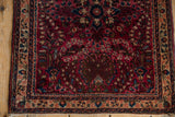 Sarouk's intricate floral border and thousand flower field in cherry red, navy, ivory.