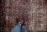 Vintage Persian Lilihan rug showing wear to foundation, cochineal red and navy florals.