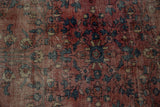 Wear across foundation on vintage Lilihan rug, revealing raspberry red field and navy plant motifs.