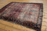 Tattered ends and worn navy border on a vintage Lilihan rug.