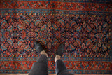 Detail of hand-knotted vintage Kurdish Hamadan rug: Herati design, navy field, madder red border.