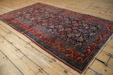 Kurdish Hamadan rug showing madder root red border, navy Herati field, and intact selvage.