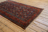 Madder root red border and intact plain weave on the secured end of a vintage Hamadan rug.