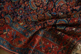 Rich pile texture showcasing navy, red, and sky blue Herati motif of a vintage Hamadan rug.