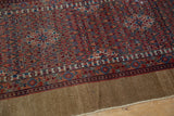 Vintage Serab runner side with intricate red, camel, blue floral vinery and visible foundation.