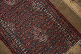 Intricate floral design, fine weave, and even wear with foundation showing on the Serab rug edge.