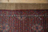 Soft pile of Serab runner: intricate cherry red, sky blue, and camel floral vinery.