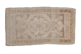 Distressed Oushak rug with muted beige and sand floral medallion, subtle seafoam hints, 1'11