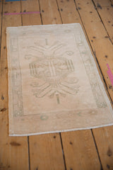 Vintage Oushak rug mat corner, with original side cord selvage, ivory, and sage border.