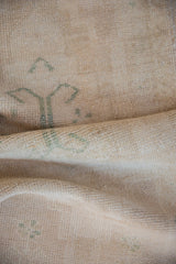 Evenly worn pile of a vintage Oushak rug, revealing seafoam green quatrefoil motifs.