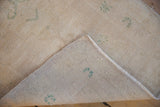 Distressed Turkish Oushak rug runner showing worn pile, woven reverse, and intact side selvage.