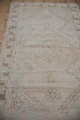 Distressed Oushak runner, showing worn cream pile, faded pale coffee bronze geometric motifs.