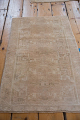 Oushak rug corner showing distressed pile with even wear, geometric motifs, and intact selvage.