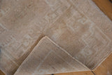 Distressed Oushak rug mat showing even pile wear, intact selvages, and woven backing.