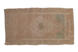 Distressed vintage Oushak runner with faded stepped medallion and subtle jade green accents. 1'9