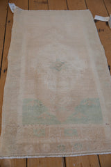 Hand-knotted vintage Oushak rug reverse side, showcasing beige foundation and 9463 tag.