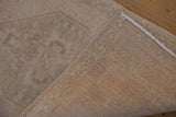 Vintage Oushak rug showing hand-knotted foundation weave and original side cord selvage.