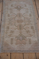 Intact side cord selvage and faded floral arabesques on the distressed Oushak rug.