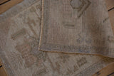 Hand-knotted reverse weave and distressed natural tones of this vintage Oushak mat.
