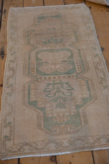 Distressed Oushak runner corner, with cream, sand, jade meandering vine border and fringe.