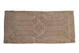 Vintage distressed Oushak rug with a faded geometric medallion in soft seafoam green on a sand field.