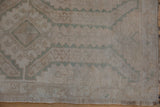 Detail view of the even wear and intact side cord selvage on a vintage Oushak rug.