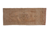 Vintage Distressed Oushak runner with faded central medallion, muted cream, sand, and dusty red border, 1'7