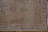 Vintage Distressed Oushak runner's side cord selvage with even wear and faded red border.