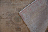 Distressed Oushak rug pile with even wear, featuring original side cord and woven reverse.