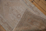 Vintage Oushak rug's hand-knotted reverse and distressed beige pile.