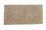 Distressed beige Oushak rug mat featuring a faded seafoam green center medallion.