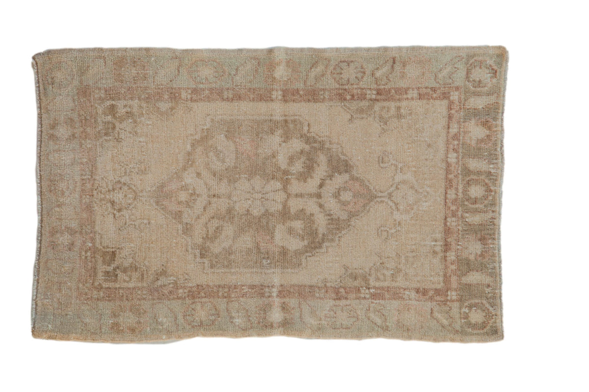 Distressed vintage Oushak rug with a stepped medallion in soft beige, mauve, and pale green.