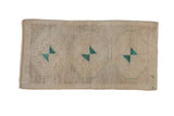 Distressed Oushak rug with triple geometric medallions in beige, ivory, and pale turquoise.