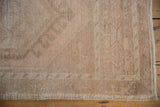 Distressed Oushak rug pile shows even wear, faint foundation, and original side cord selvage.
