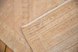 Distressed Oushak rug showing worn beige pile and hand-knotted reverse foundation.