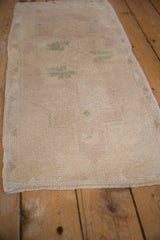 Distressed vintage Oushak rug texture with even wear and faded beige, seafoam green.