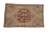 Vintage distressed Oushak mat with beige field, dusty copper medallion, floral motifs, and oxidized silver.