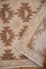 Distressed pile of serrated floral guls and vertically striped woven reverse with intact selvage.