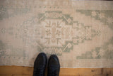 Overhead view of a vintage Oushak runner highlighting its worn, low-pile texture and scale.