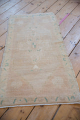 Distressed Oushak rug side cord selvage and soft abrashed pile with faded dusty turquoise green.