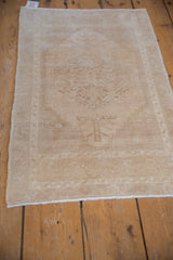 Distressed Oushak rug pile, revealing faint foundation and soft beige floral patterns.