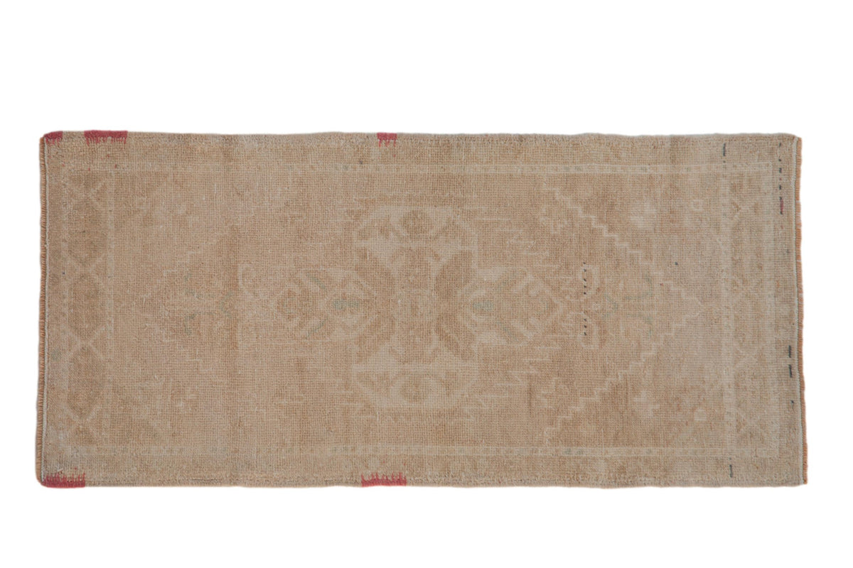 Distressed Oushak runner with a faint, scalloped medallion in soft beige and antique ivory.